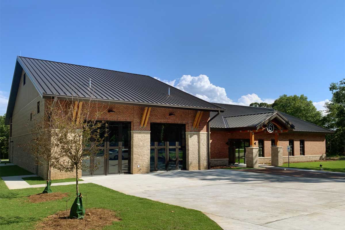 This new single story Fire Station in Alabama houses living and sleeping quarters, a kitchen and office space.